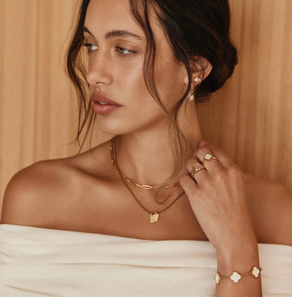 Mother-of-pearl clover bracelet on a wrist